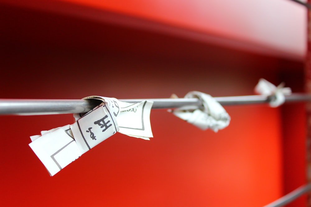 a close up of a metal bar with some tags on it